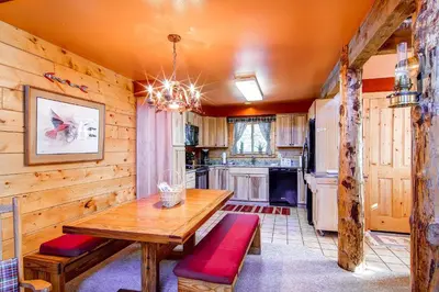 a dining room with a wooden table and a kitchen at 597 Deerpath in Dillon