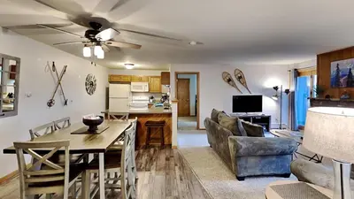 a living room with a dining room table and a couch at AA302 Buffalo Village in Silverthorne