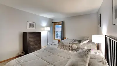 a bedroom with a bed and a dresser at AA302 Buffalo Village in Silverthorne