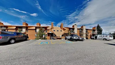 a parking lot in front of a large building at CC102 Buffalo Village in Silverthorne