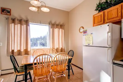 a kitchen and dining room with a table and a refrigerator at B-101 Buffalo Ridge in Silverthorne