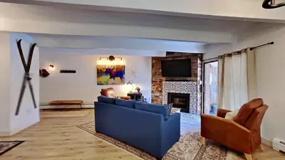 a living room with a blue couch and a fireplace at Ten Mile Island C220 in Frisco