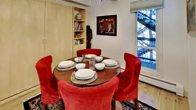 a dining room with a wooden table and red chairs at Ten Mile Island C220 in Frisco