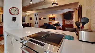 a kitchen with a stove and a living room at Ten Mile Island C220 in Frisco