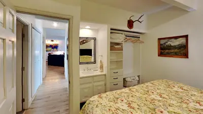a bedroom with a bed and a bathroom with a sink at Ten Mile Island C220 in Frisco