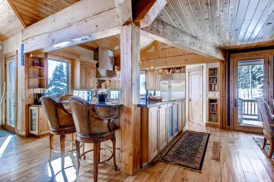 a kitchen with a table and chairs in a cabin at Three Peaks Mountain Lodge in Silverthorne