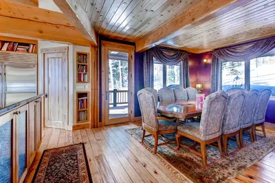 a dining room with a table and chairs at Three Peaks Mountain Lodge in Silverthorne