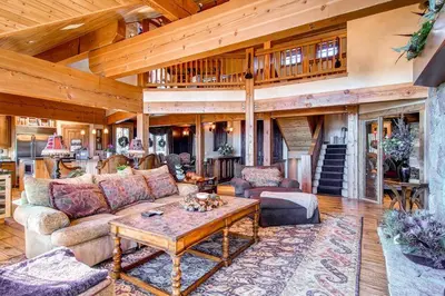 a living room with a couch and a table at Three Peaks Mountain Lodge in Silverthorne