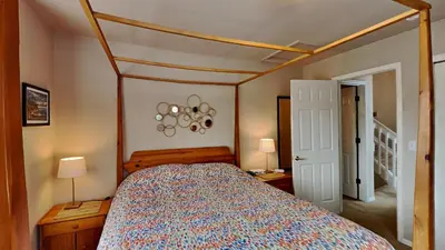 a bedroom with a bed with a wooden canopy at 33 Corinthian Circle in Dillon