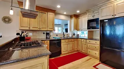 a kitchen with wooden cabinets and a black refrigerator at 33 Corinthian Circle in Dillon