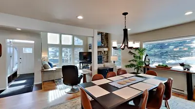 a dining room and living room with a table and chairs at 33 Corinthian Circle in Dillon