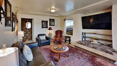 a living room with a couch and a tv at Hummingbird House in Silverthorne