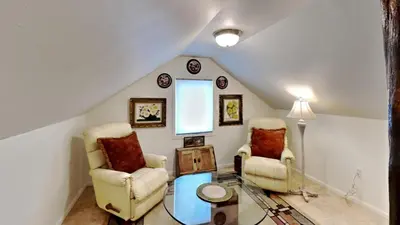 a living room with two chairs and a table at Hummingbird House in Silverthorne