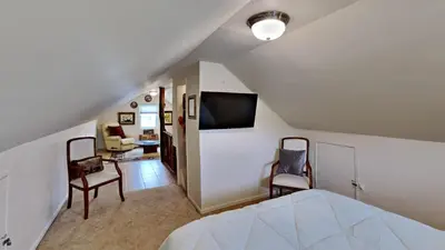 a bedroom with a bed and a living room at Hummingbird House in Silverthorne