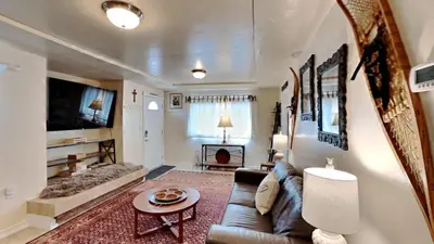 a living room with a couch and a table at Hummingbird House in Silverthorne
