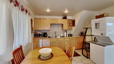 a kitchen with a wooden table and a white refrigerator at Hummingbird House in Silverthorne