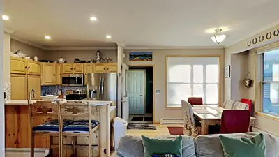 a kitchen and living room with a table and chairs at Miners Run 79 in Silverthorne