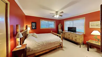 a bedroom with orange walls and a bed and a television at Miners Run 79 in Silverthorne
