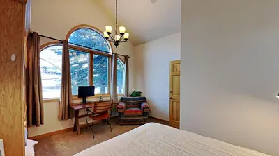 a bedroom with a bed and a desk and a window at 36 James Court in Dillon
