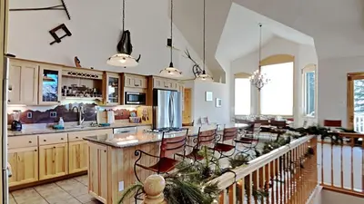 a large kitchen with a island with chairs in it at 36 James Court in Dillon