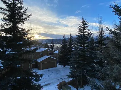 a house in the snow with trees at 36 James Court in Dillon