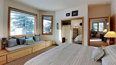 a bedroom with a large bed and a large window at 36 James Court in Dillon