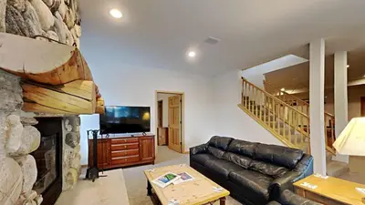a living room with a leather couch and a fireplace at 36 James Court in Dillon