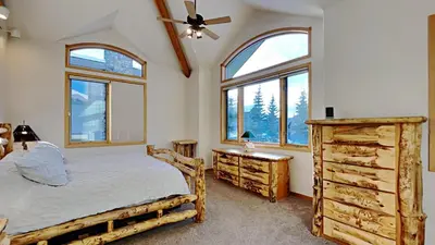 a bedroom with a bed and two windows at 36 James Court in Dillon