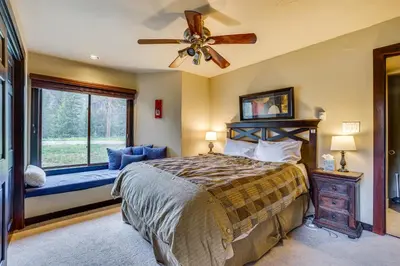 a bedroom with a bed with a fan and a window at Dillon Vacation Rental 1 Mi to Keystone Resort in Dillon