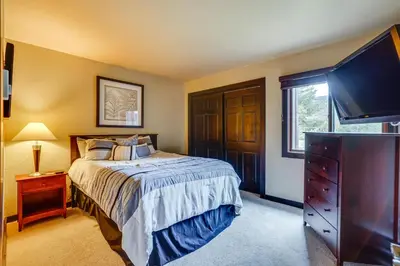 a bedroom with a bed and a flat screen tv at Dillon Vacation Rental 1 Mi to Keystone Resort in Dillon