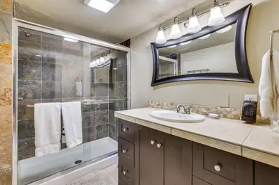 a bathroom with a shower and a sink and a mirror at Dillon Vacation Rental 1 Mi to Keystone Resort in Dillon