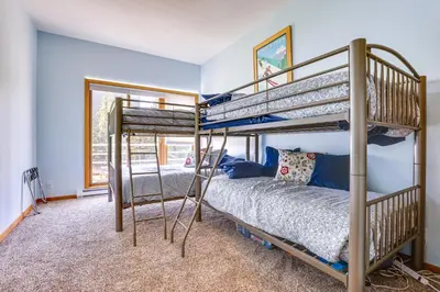 a bedroom with two bunk beds and a bed at Winter Park Condo Rental 4 Mi to Ski Resort! in Winter Park