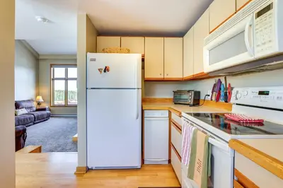 a kitchen with a refrigerator and a stove at Winter Park Condo Rental 4 Mi to Ski Resort! in Winter Park