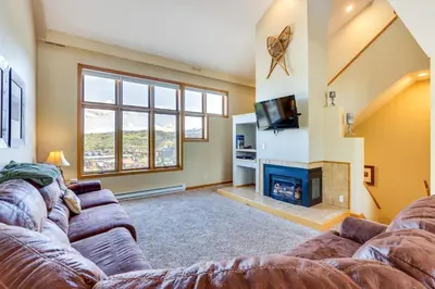 a living room with a couch and a fireplace at Winter Park Condo Rental 4 Mi to Ski Resort! in Winter Park