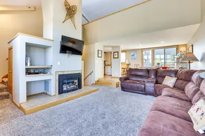 a living room with a couch and a fireplace at Winter Park Condo Rental 4 Mi to Ski Resort! in Winter Park