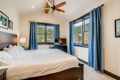 a bedroom with a bed and a ceiling fan at Alders 4 Bedroom Townhome In East Keystone in Keystone