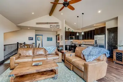 a living room with two couches and a table at Alders 4 Bedroom Townhome In East Keystone in Keystone