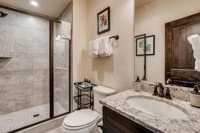 a bathroom with a shower and a toilet and a sink at Alders 4 Bedroom Townhome In East Keystone in Keystone