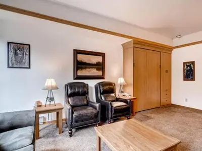 a living room with two chairs and a couch at Keystone Slopeside Studio Condo in Keystone