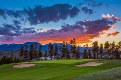 a golf course with a sunset in the background at Keystone Slopeside Studio Condo in Keystone