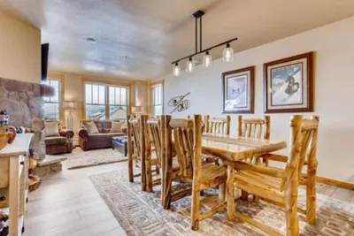 a dining room and living room with a table and chairs at River Run Village 3 Bedroom Condo in Keystone
