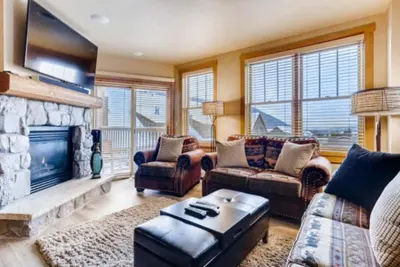 a living room with a couch and a fireplace at River Run Village 3 Bedroom Condo in Keystone