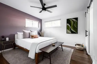 a bedroom with a bed with a ceiling fan at Chic Mid-Century Home Near Olde Town Arvada in Arvada