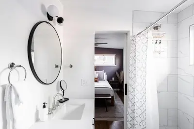 a bathroom with a sink and a mirror at Chic Mid-Century Home Near Olde Town Arvada in Arvada