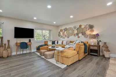a living room with a couch and a table at NEW: Tulum Oasis in Denver w/ Hot Tub & Games in Denver