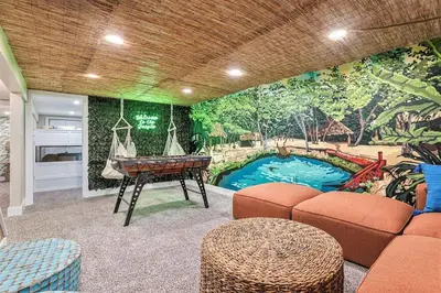 a living room with a ping pong table and a mural at NEW: Tulum Oasis in Denver w/ Hot Tub & Games in Denver