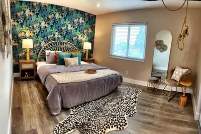 a bedroom with a bed with a floral wallpaper at NEW: Tulum Oasis in Denver w/ Hot Tub & Games in Denver