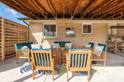 a patio with a table and chairs on a patio at NEW: Tulum Oasis in Denver w/ Hot Tub & Games in Denver