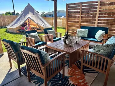 a patio with a table and chairs and a tent at NEW: Tulum Oasis in Denver w/ Hot Tub & Games in Denver