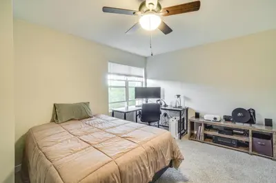 a bedroom with a bed and a ceiling fan at 16 Mi to DIA Townhome with Fireplace in Aurora in Aurora
